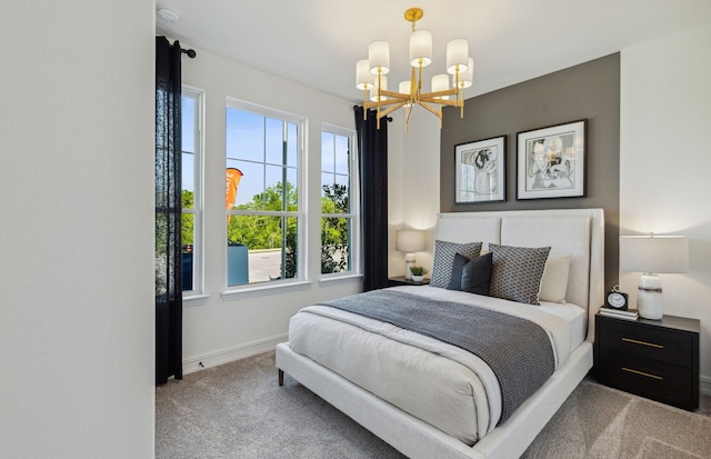 carpeted bedroom featuring a notable chandelier