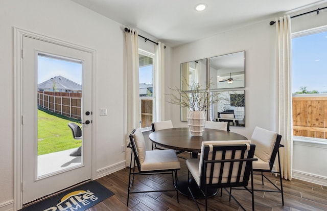 dining area with ceiling fan and dark wood-type flooring