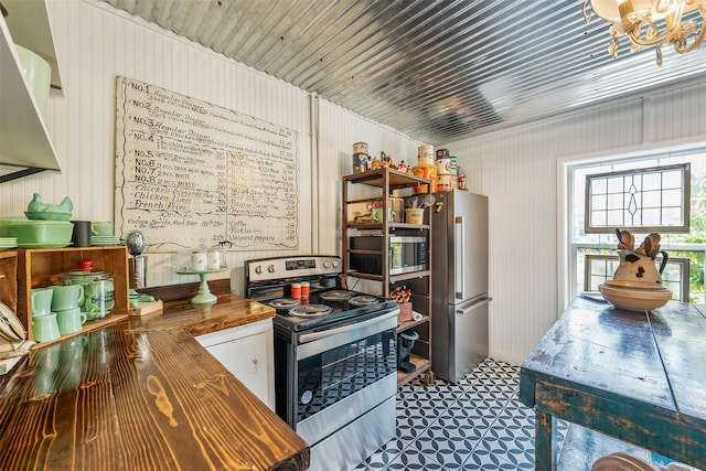 kitchen with appliances with stainless steel finishes and butcher block counters