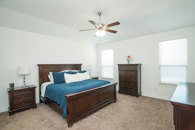 bedroom featuring baseboards, ceiling fan, and light colored carpet