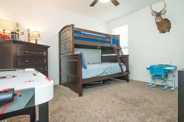 carpeted bedroom with a ceiling fan and baseboards