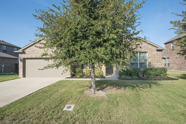 view of property hidden behind natural elements with a garage, concrete driveway, brick siding, and a front lawn