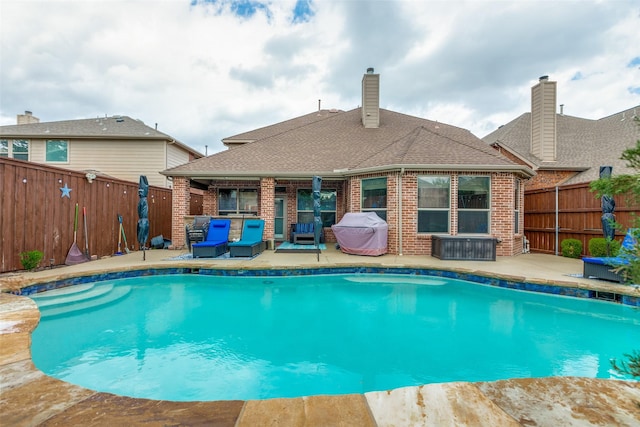 view of swimming pool featuring a patio area, a fenced in pool, and a fenced backyard