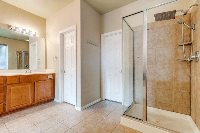 bathroom with walk in shower, vanity, and tile patterned flooring