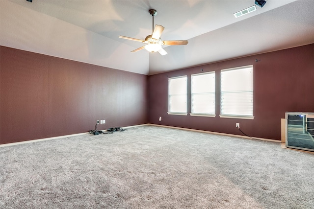 unfurnished room featuring ceiling fan, heating unit, carpet floors, and lofted ceiling