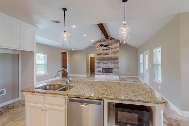 kitchen featuring a brick fireplace, lofted ceiling with beams, sink, dishwasher, and light stone countertops