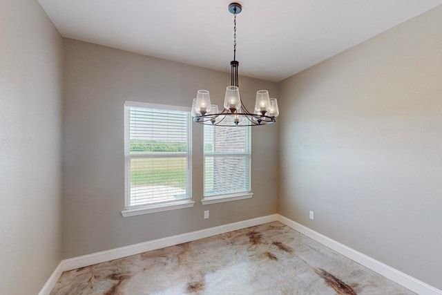 unfurnished dining area featuring an inviting chandelier