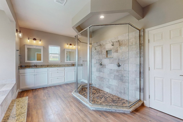 bathroom featuring vanity, hardwood / wood-style floors, and an enclosed shower