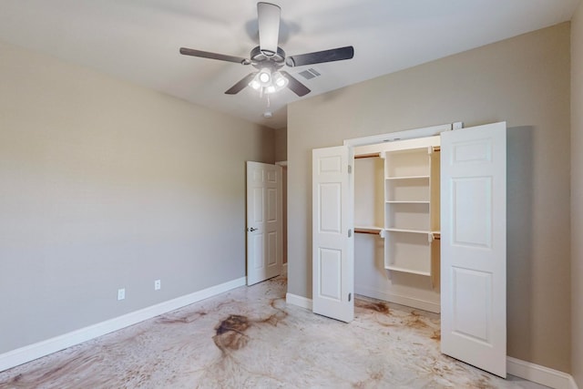 unfurnished bedroom with a closet, a walk in closet, and ceiling fan