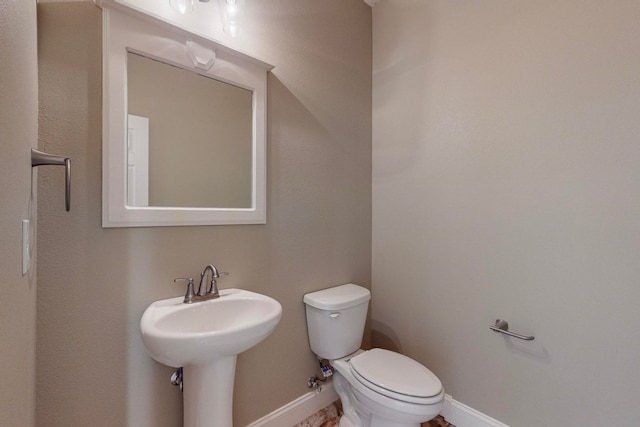 bathroom featuring sink and toilet