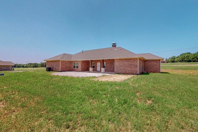 rear view of property with a patio and a yard