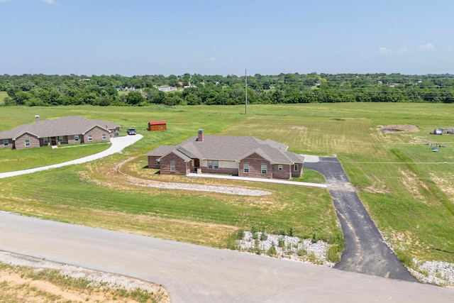 birds eye view of property with a rural view