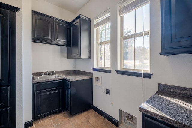 laundry area with a sink, electric dryer hookup, cabinet space, baseboards, and washer hookup
