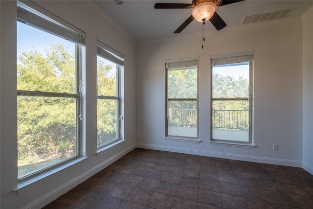 spare room with plenty of natural light, visible vents, and crown molding