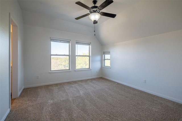 interior space featuring lofted ceiling, a ceiling fan, and baseboards