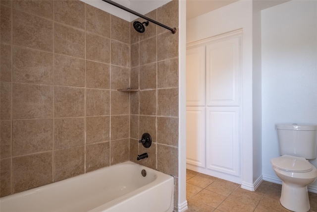 bathroom with tile patterned flooring,  shower combination, and toilet