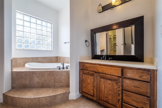 full bath featuring vanity, a garden tub, and tile patterned flooring