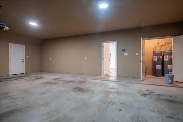 garage featuring water heater and recessed lighting