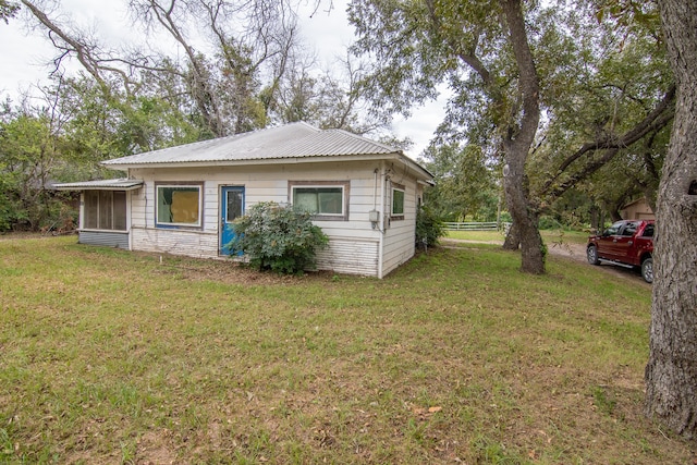 view of side of property with a lawn