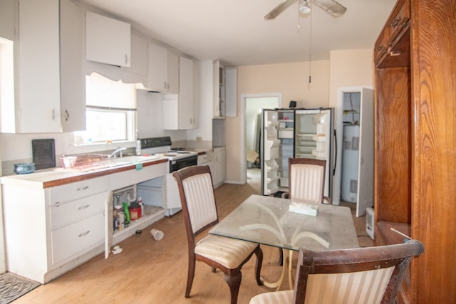 kitchen featuring white cabinets, light wood-type flooring, and white range with electric cooktop