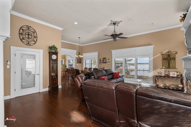 living room with ornate columns, ceiling fan with notable chandelier, crown molding, and dark hardwood / wood-style flooring