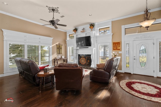 living room with ornamental molding, ceiling fan, and dark hardwood / wood-style floors