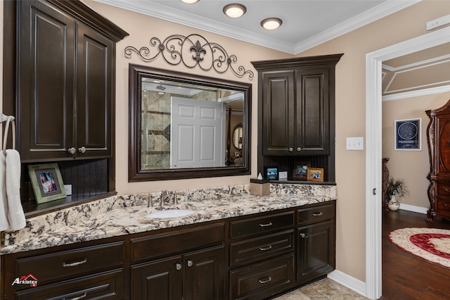 bathroom with hardwood / wood-style flooring, crown molding, and vanity