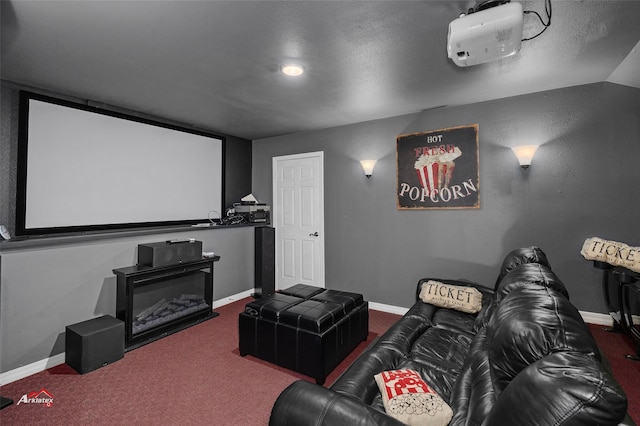 cinema with vaulted ceiling and carpet flooring