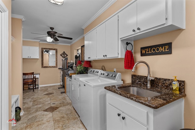 laundry area with ceiling fan, ornamental molding, sink, washing machine and clothes dryer, and cabinets