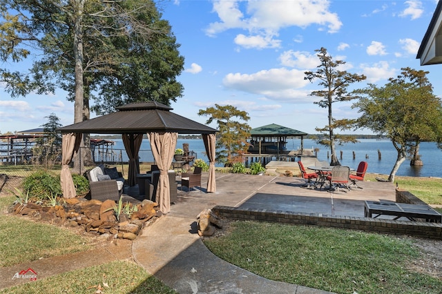 view of yard featuring a water view, a gazebo, and a patio