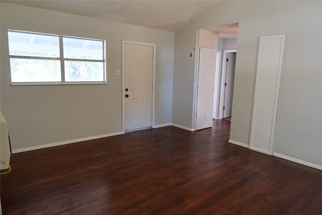 unfurnished room featuring dark wood-type flooring