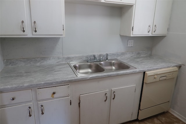 kitchen with dishwasher, white cabinets, and sink