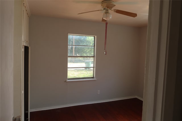 unfurnished room featuring ceiling fan and dark wood-type flooring