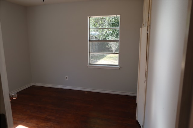 empty room with dark wood-type flooring