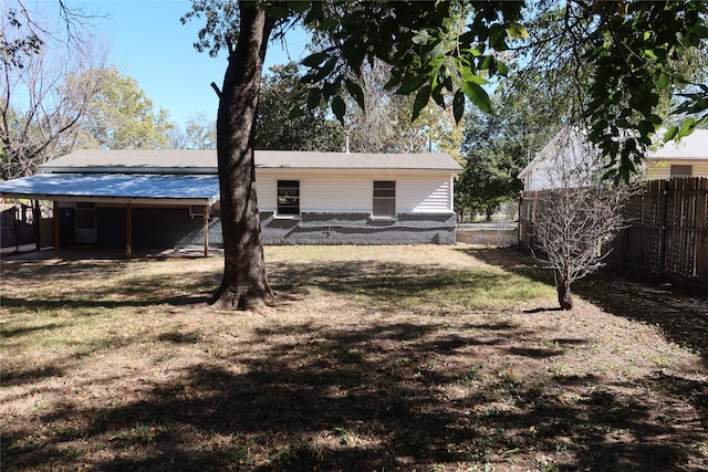 back of house with a lawn