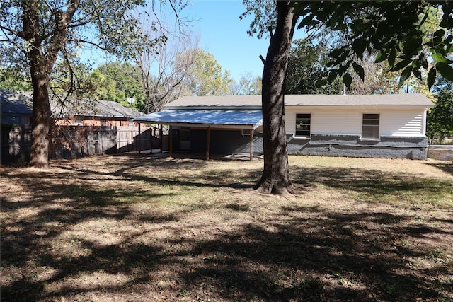 back of property with a lawn