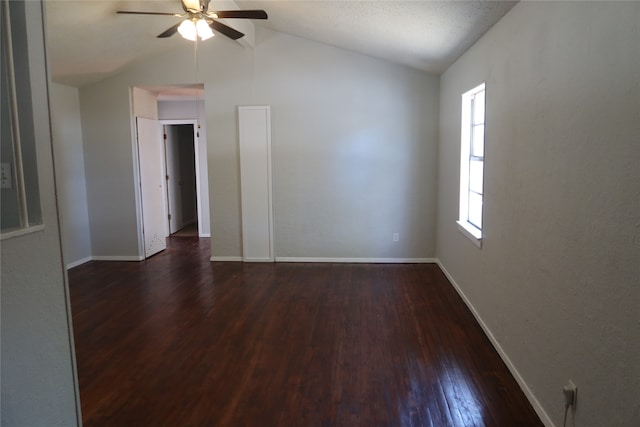 spare room with lofted ceiling, ceiling fan, and dark hardwood / wood-style floors