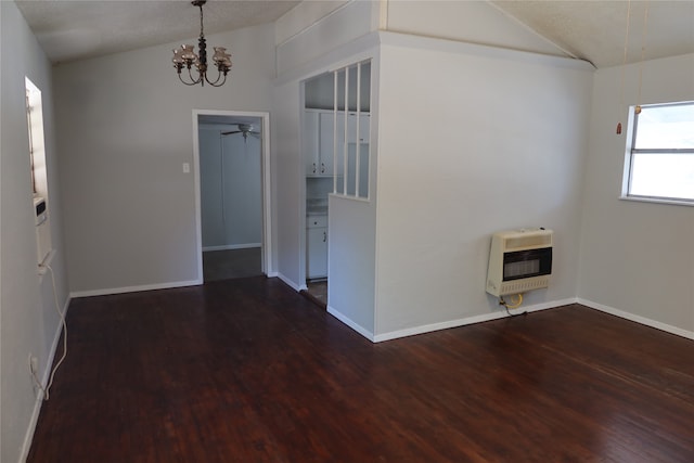 spare room with vaulted ceiling, dark hardwood / wood-style floors, and heating unit