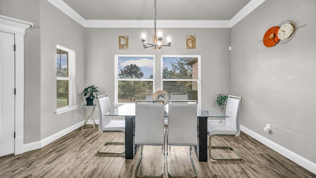 dining area featuring crown molding, hardwood / wood-style floors, and an inviting chandelier