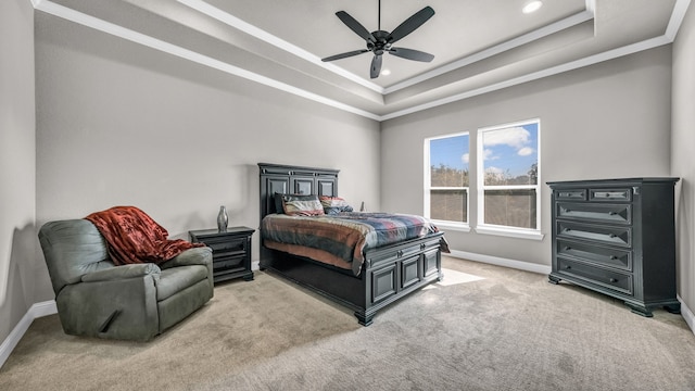 carpeted bedroom with a raised ceiling, crown molding, and ceiling fan