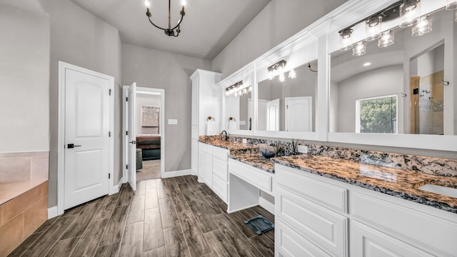 bathroom with vanity, wood-type flooring, and shower with separate bathtub