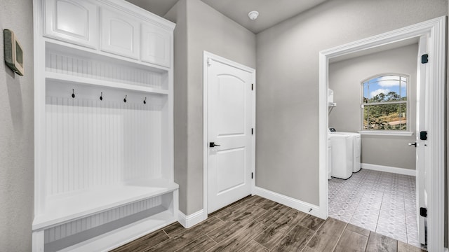 mudroom with washing machine and clothes dryer and hardwood / wood-style floors