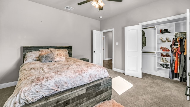 carpeted bedroom with ceiling fan and a closet