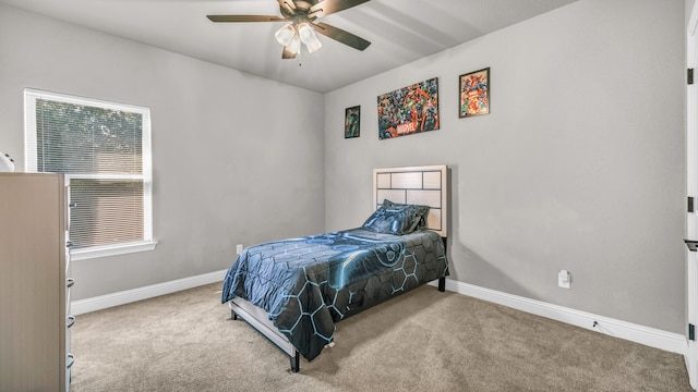 bedroom featuring multiple windows, ceiling fan, and light colored carpet