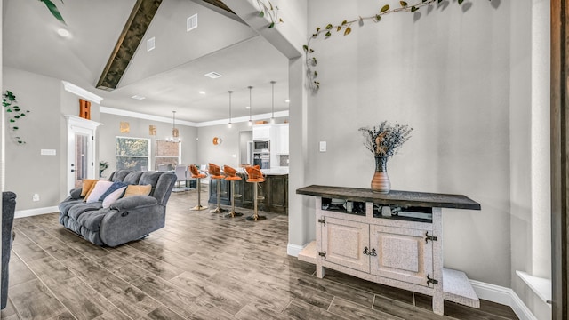 living room featuring wood-type flooring, crown molding, beam ceiling, and high vaulted ceiling