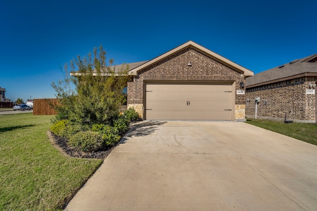 ranch-style house featuring a front lawn and a garage