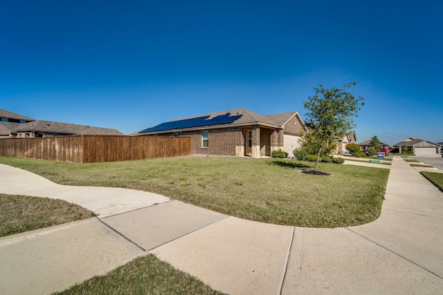 view of front of property featuring a garage and a front lawn