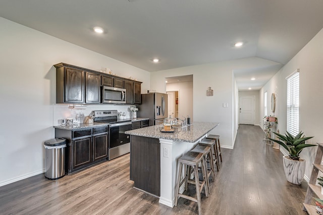 kitchen featuring dark brown cabinets, sink, lofted ceiling, dark hardwood / wood-style floors, and appliances with stainless steel finishes