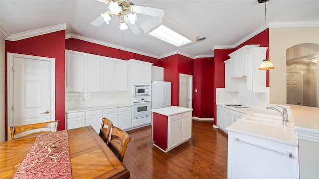 kitchen featuring ceiling fan, hanging light fixtures, white appliances, dark hardwood / wood-style flooring, and decorative backsplash