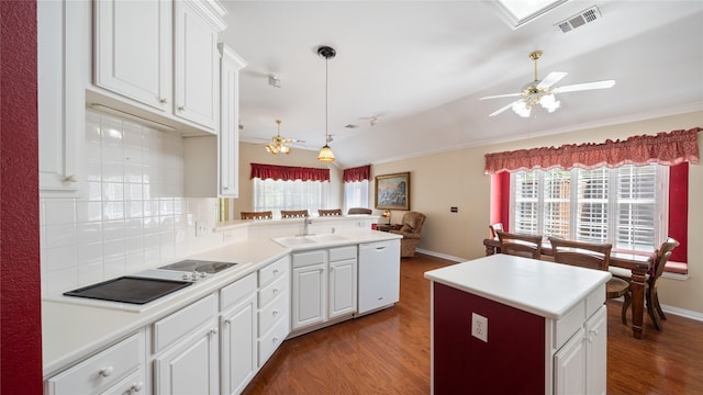 kitchen featuring white dishwasher, dark hardwood / wood-style floors, sink, and decorative backsplash